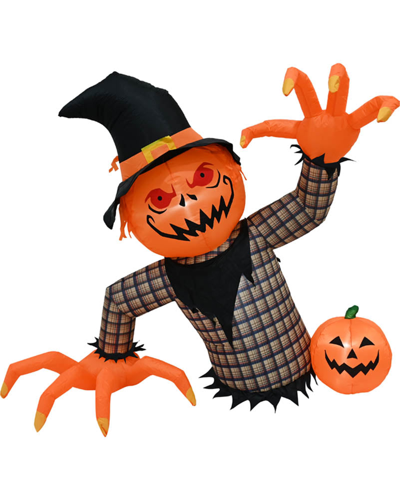 Inflatable Halloween scarecrow decoration with an orange jack-o'-lantern head, black witch hat, plaid body, and orange clawed hands, shown on a plain white background with a small pumpkin beside it.