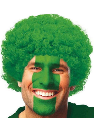 Image of man wearing green curly wig. 