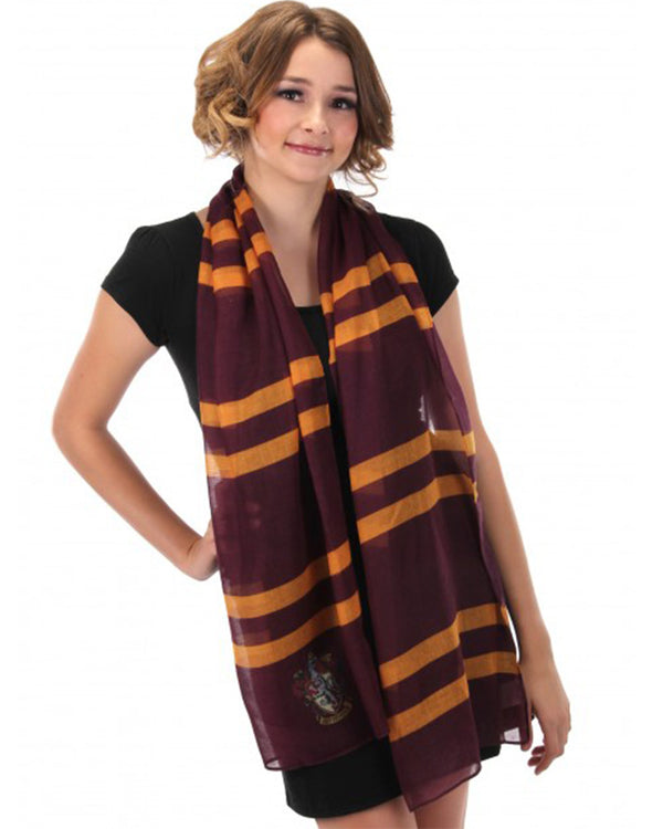 Image of woman wearing maroon and yellow Harry Potter Gryffindor scarf.