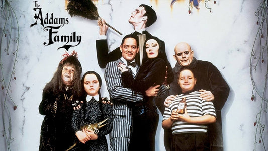 Image of cast of the Addams Family Including Morticia, Gomez and Wednesday.