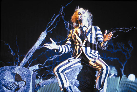 Image of Beetlejuice in black and white striped suit. 
