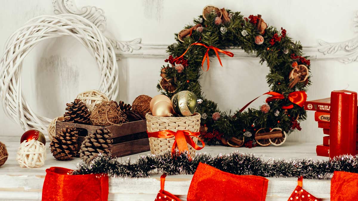 Image of Christmas decorations including green and white wreaths and pinecones.