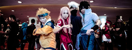 Image of three men and one woman dressed in anime cosplay costumes. 