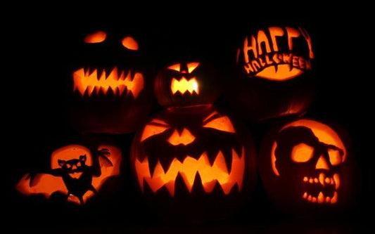 Image of carved pumpkins glowing in the dark. 