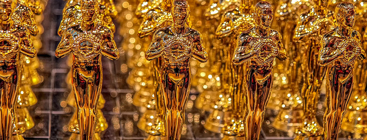 Image of lots of gold Oscar statues all lined up.