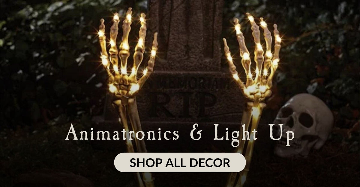 Light up skeleton hands coming out of a grave with the words Animatronics and Light Up. Click to shop all Halloween Decor.