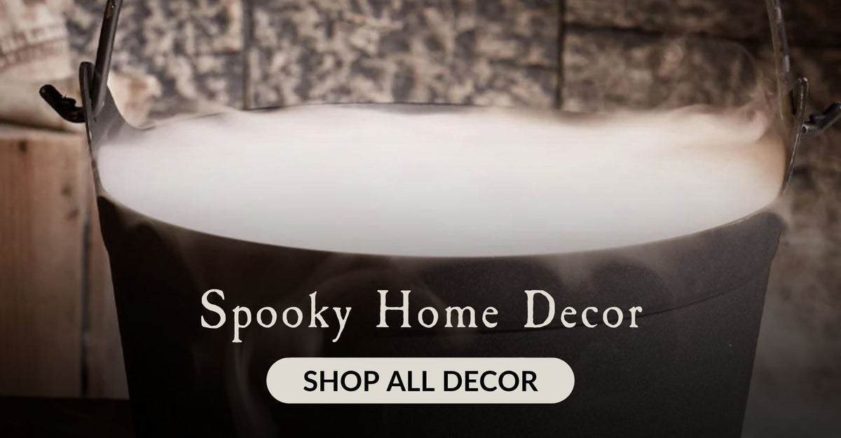 A black caldron with fog coming out and the words Spooky Home Decor. Click to shop all Halloween Decor.
