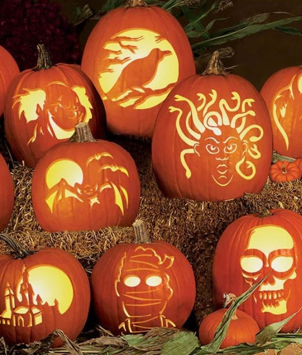 Arrangement of carved jack-o'-lantern pumpkins featuring carved designs like Medusa, a skull, a raven, and a mummy. Click to shop all Halloween Pumpkins and carving.