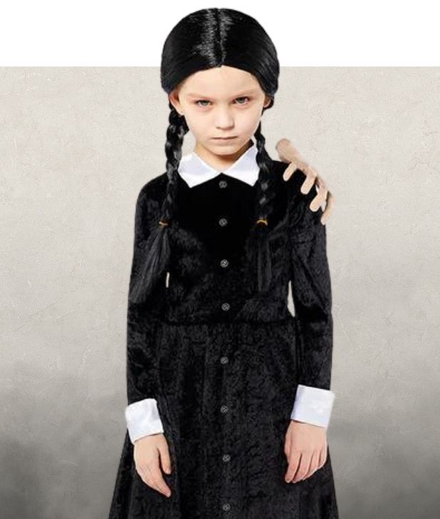 A girl wearing a Wednesday Addams Halloween costume on a beige background. Click to shop all Addams Family Halloween Costumes. 