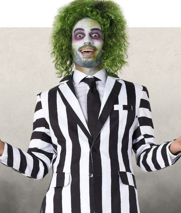 A man wearing a Beetlejuice Costume on a beige background. Click to shop all Beetlejuice Halloween Costumes. 