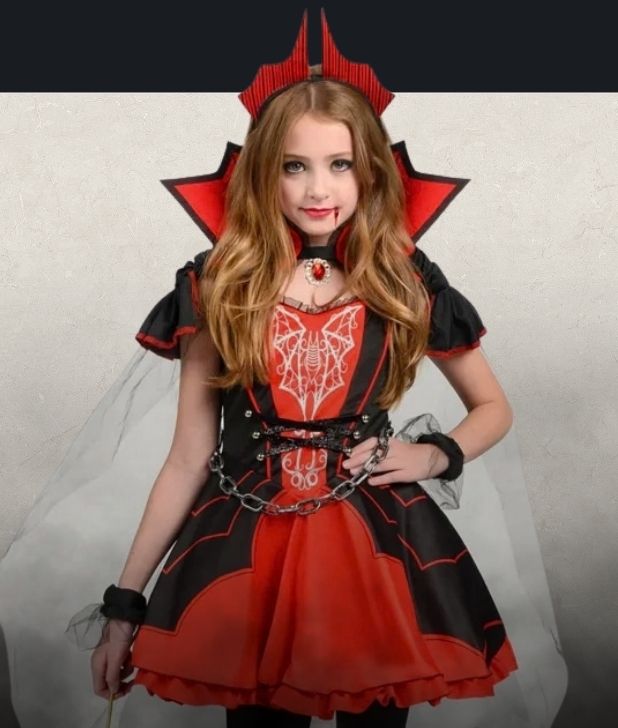 A beige background with black fog at the bottom. Features a girls vampire character. Click to shop all Vampire Costumes and accessories.