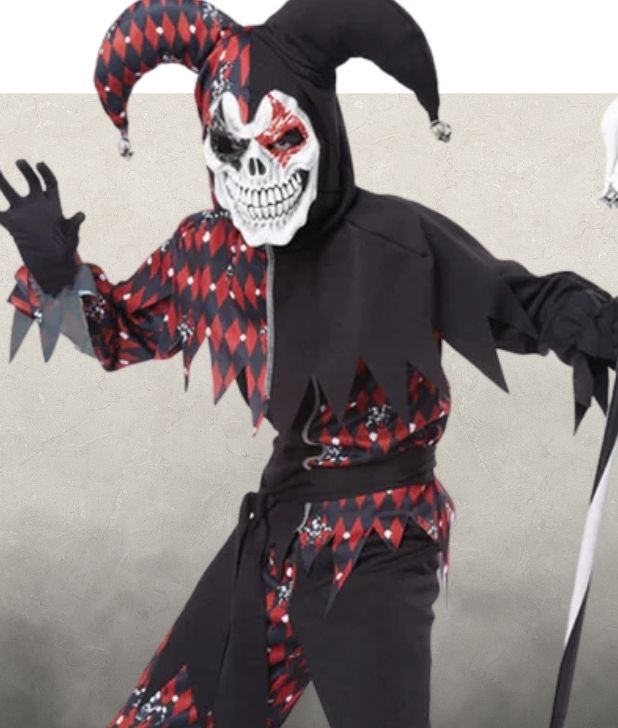 A boy wearing a black and red clown costume on a beige background. Click to shop all creepy clowns halloween costumes. 