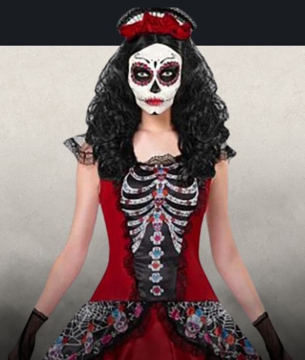 A beige background with black fog at the bottom. Features a womens Day of the Dead character. Click to shop all Day of the Dead Costumes and accessories.