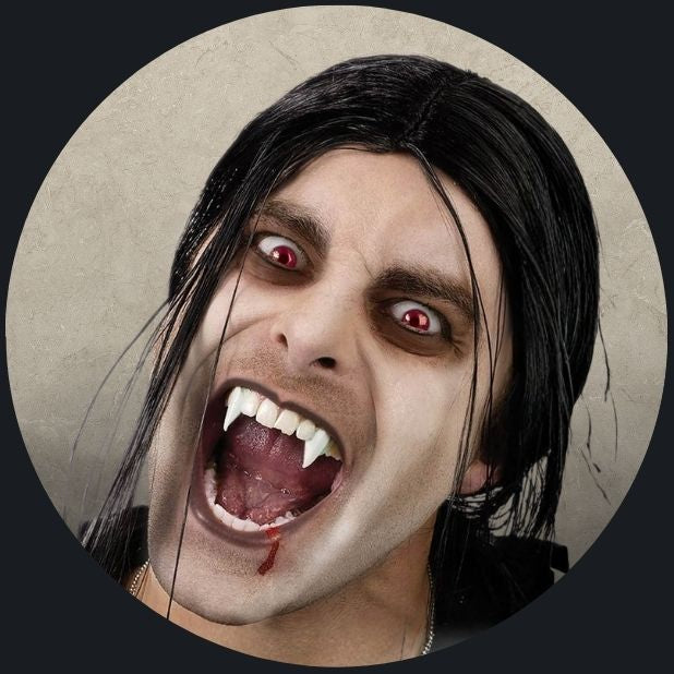 A beige circle with a man with vampire teeth. Click to shop all Halloween fangs and teeth.