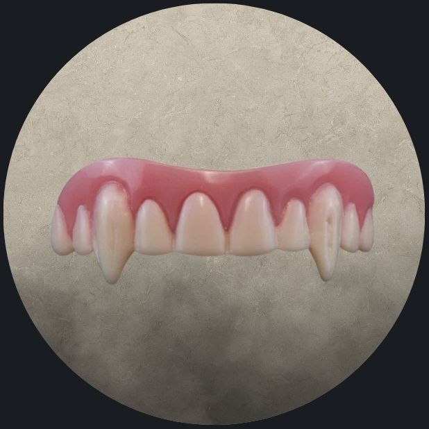A beige circle with vampire teeth. Click to shop all Halloween fangs and teeth.