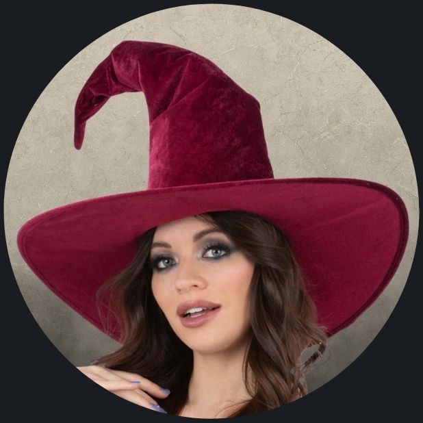 A beige circle with a woman wearing a maroon velvet witch hat. Click to shop all Halloween hats and head wear.
