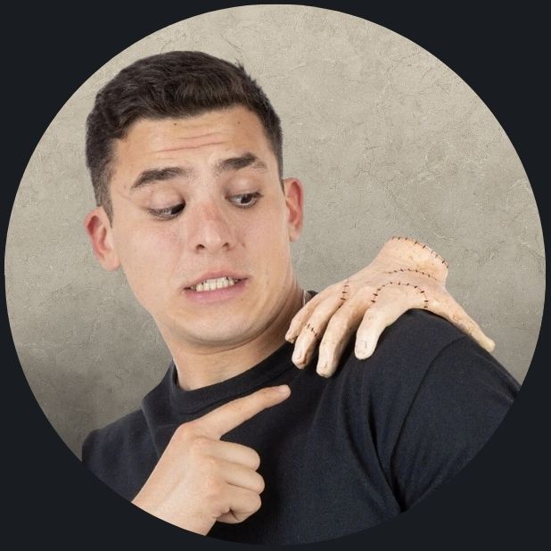 A beige circle with a man with the Addams Family Thing Hand on his shoulder. Click to shop all Halloween Accessories. 