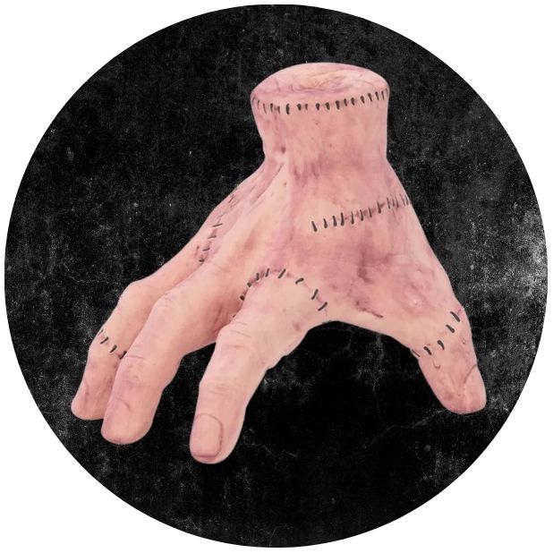 A black circle with the Addams Family Thing Hand. Click to shop all Halloween Accessories. 