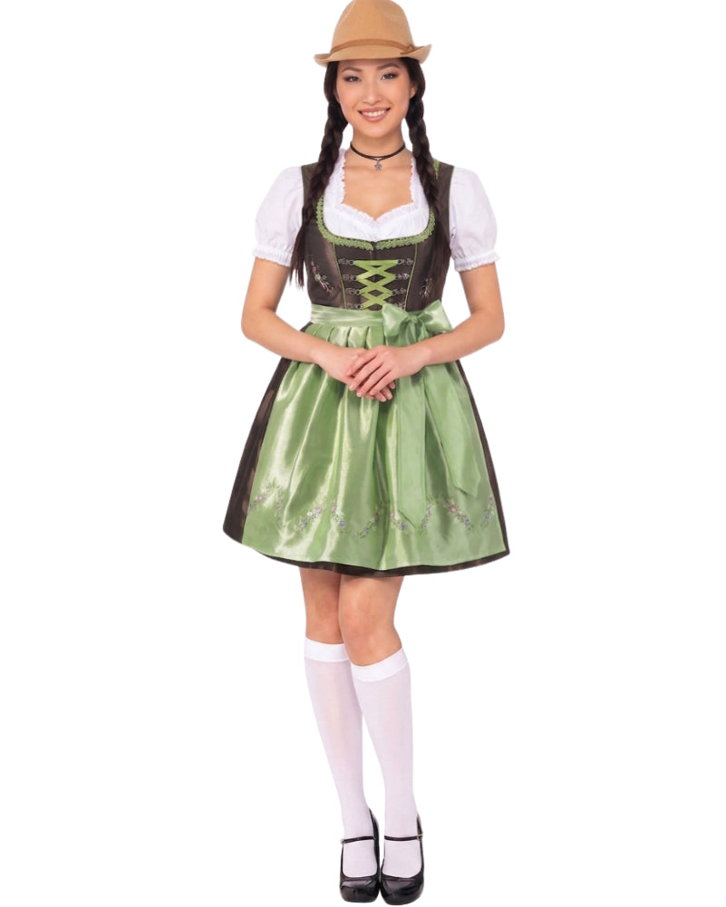 A woman modeling a traditional German dirndl costume against a plain white background. The costume includes a green satin skirt with dark brown trim, a white short-sleeve bodice overlay, a dark brown faux-leather corset-style vest with green lace-up detailing, a white collar, white knee-high socks, black Mary Jane shoes, and a tan hat.