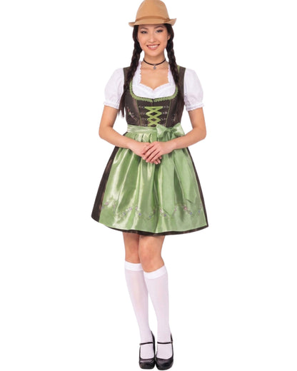 A woman modeling a traditional German dirndl costume against a plain white background. The costume includes a green satin skirt with dark brown trim, a white short-sleeve bodice overlay, a dark brown faux-leather corset-style vest with green lace-up detailing, a white collar, white knee-high socks, black Mary Jane shoes, and a tan hat.