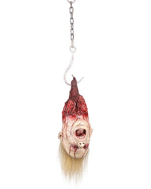 Horror-themed decoration of a severed head with blonde hair on a hook against a white background.