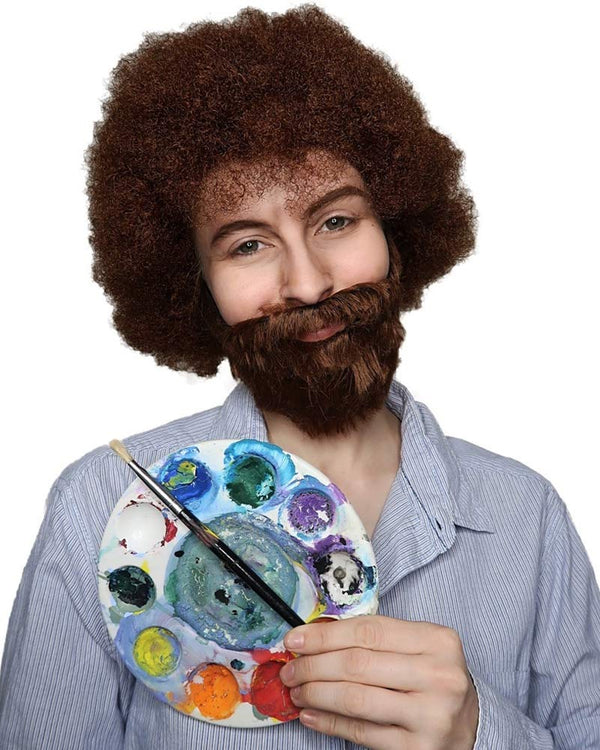 Person wearing a brown wig and holding a paint palette with a brush