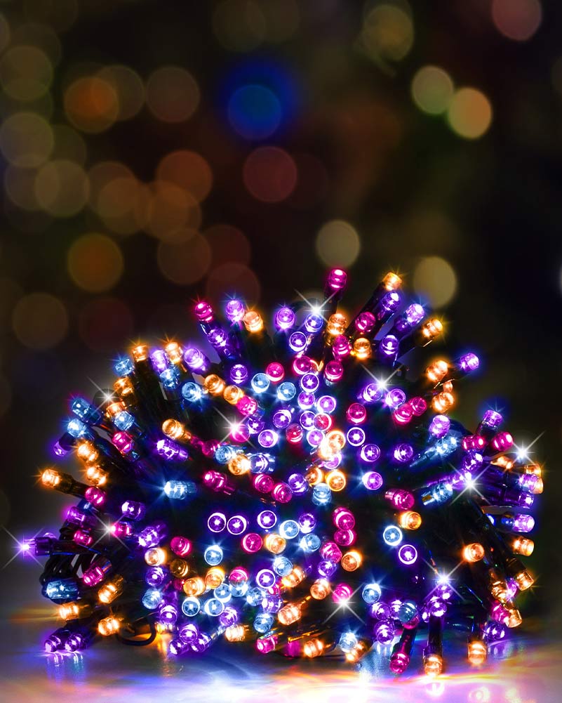 A bundle of multicolor LED string lights glowing with purple, blue, orange, and pink lights, set against a dark background with colorful bokeh.