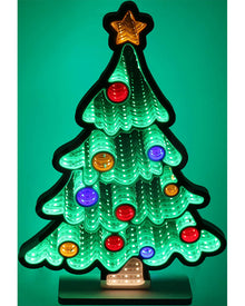 A glowing Christmas tree light with a green illuminated tree shape, multicolored round ornaments, a gold star topper, and a small warm light at the base, shown against a green background.