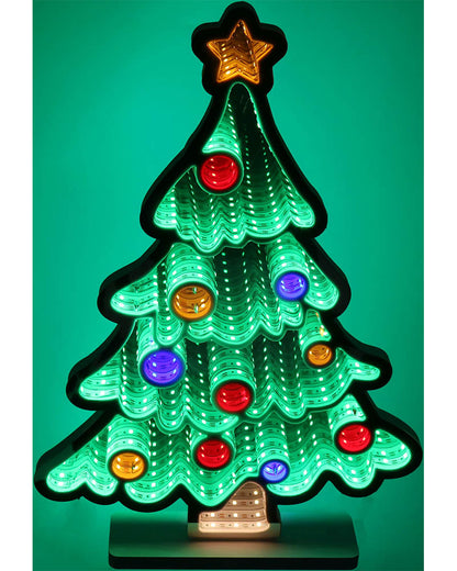 A glowing Christmas tree light with a green illuminated tree shape, multicolored round ornaments, a gold star topper, and a small warm light at the base, shown against a green background.