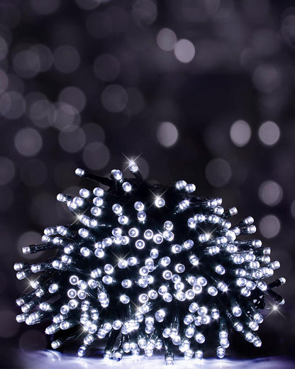 A bundle of white LED string lights glowing brightly against a dark, blurred bokeh background.