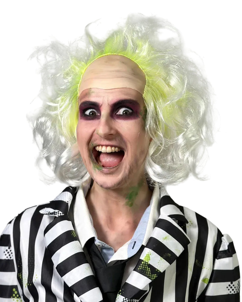 A person wearing a Beetlejuice-style costume with a black-and-white striped jacket, black tie, pale makeup, and a bright neon yellow wig, photographed against a plain gray background.