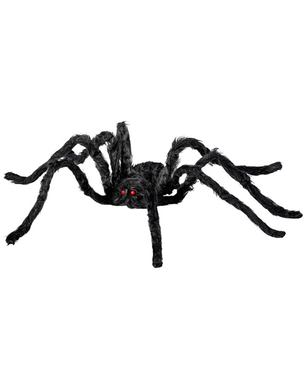Black spider toy with red eyes on a white background