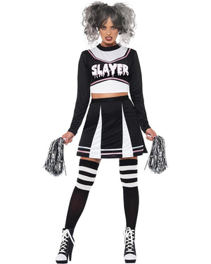 Person wearing a black and white costume with 'SLAYER' text, holding pom-poms on a white background