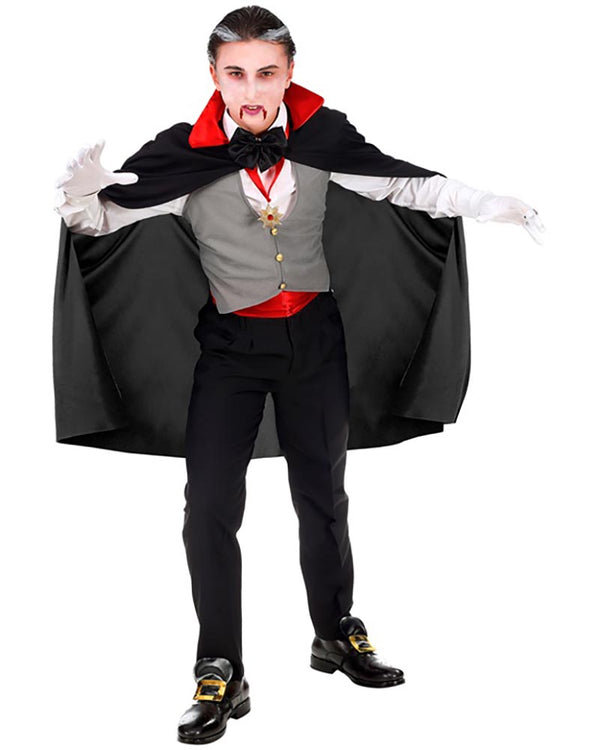 Person in a vampire costume with a black cape, red shirt, and gray vest on a white background