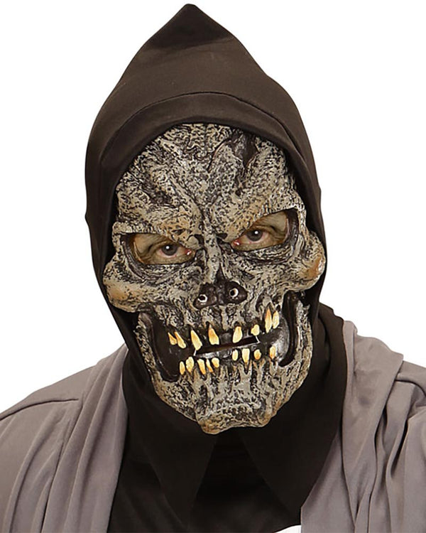 Person wearing a dark hooded outfit with a detailed skull mask on a white background