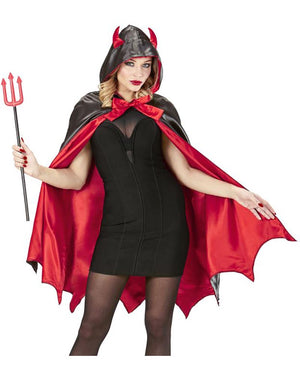 Person wearing a devil costume with a red cape and black outfit, holding a pitchfork.