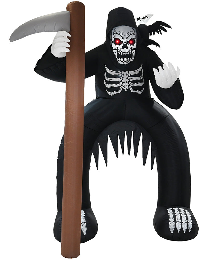 An inflatable Grim Reaper Halloween decoration in black, featuring a skull face with glowing red eyes, white skeletal details, bat wings, a large scythe with a brown handle, and sharp teeth along the bottom, isolated on a white background.