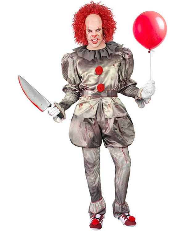 Person in a horror clown costume holding a knife and a red balloon on a white background