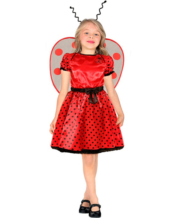 Child wearing a red ladybug costume with black polka dots on a white background