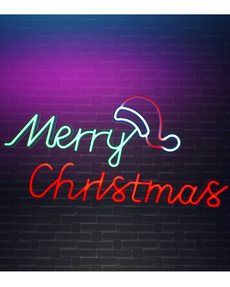 A neon sign reading 'Merry Christmas' with a Santa hat outline, mounted on a dark brick wall. The letters glow in mint green and red, with the hat outlined in white and red.