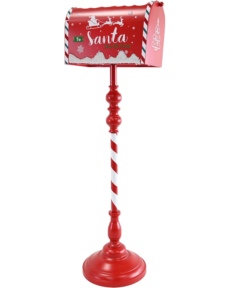 A festive Christmas mailbox on a red pedestal stand. The mailbox is red with white snowflakes, a striped border, and 'Santa' written on the front.