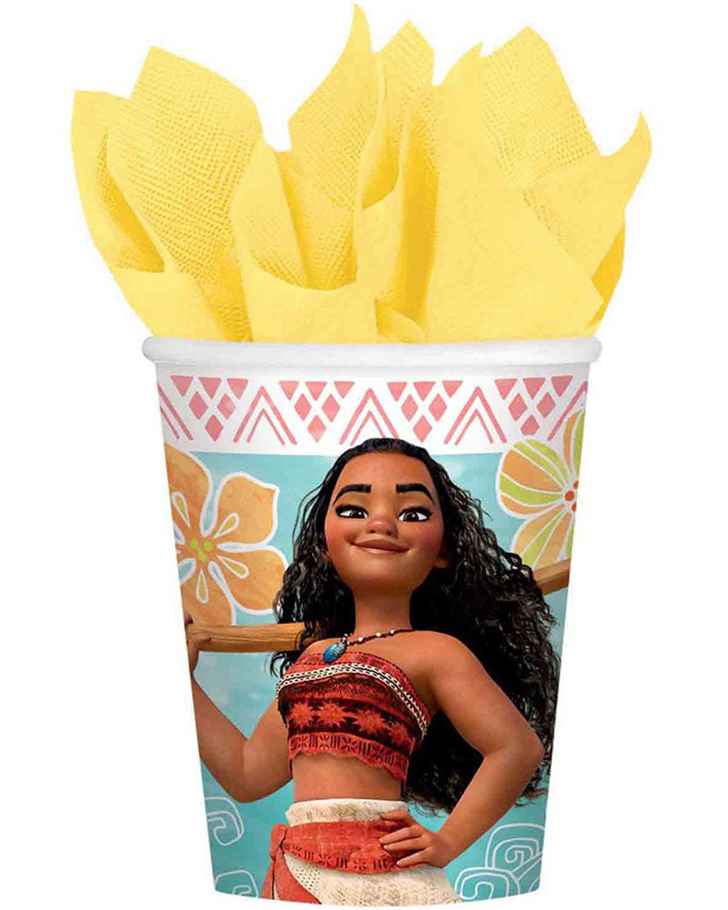 A Moana-themed paper party cup printed with the character Moana, filled with yellow paper napkins, on a plain white background.
