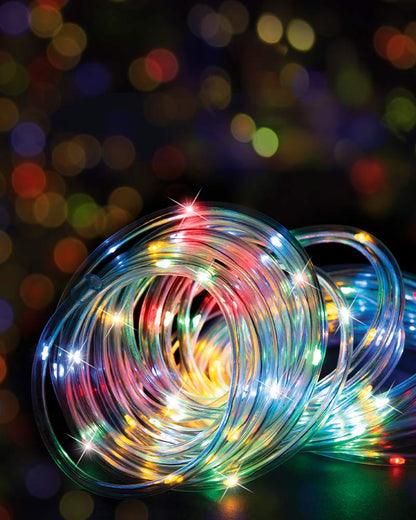 Coiled multicolor LED string lights with thin transparent wires and glowing bulbs in red, green, blue, yellow, and white, set against a dark background with colorful bokeh lights.