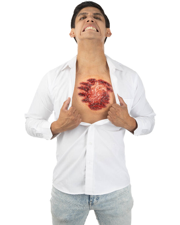 Man wearing a white shirt with a graphic of a red open chest and organ on his chest.
