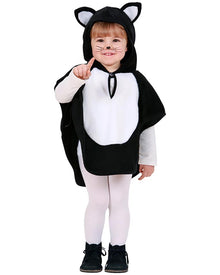 Child wearing a black and white cat costume on a white background