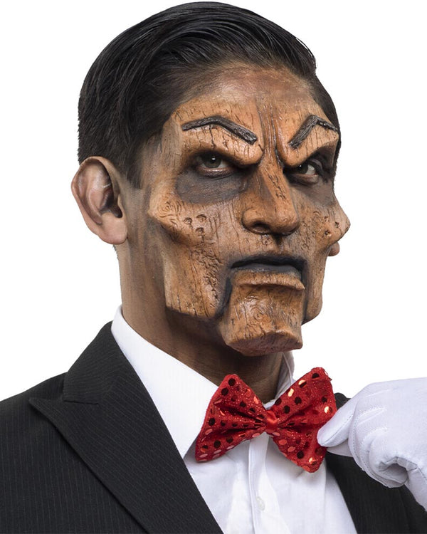 Person wearing a wooden mask with a suit and red bow tie on a white background