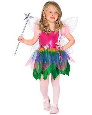 Child in a colorful fairy costume with a wand on a white background