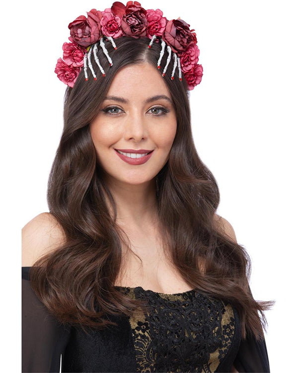 Woman wearing a floral headband with pink flowers on a white background