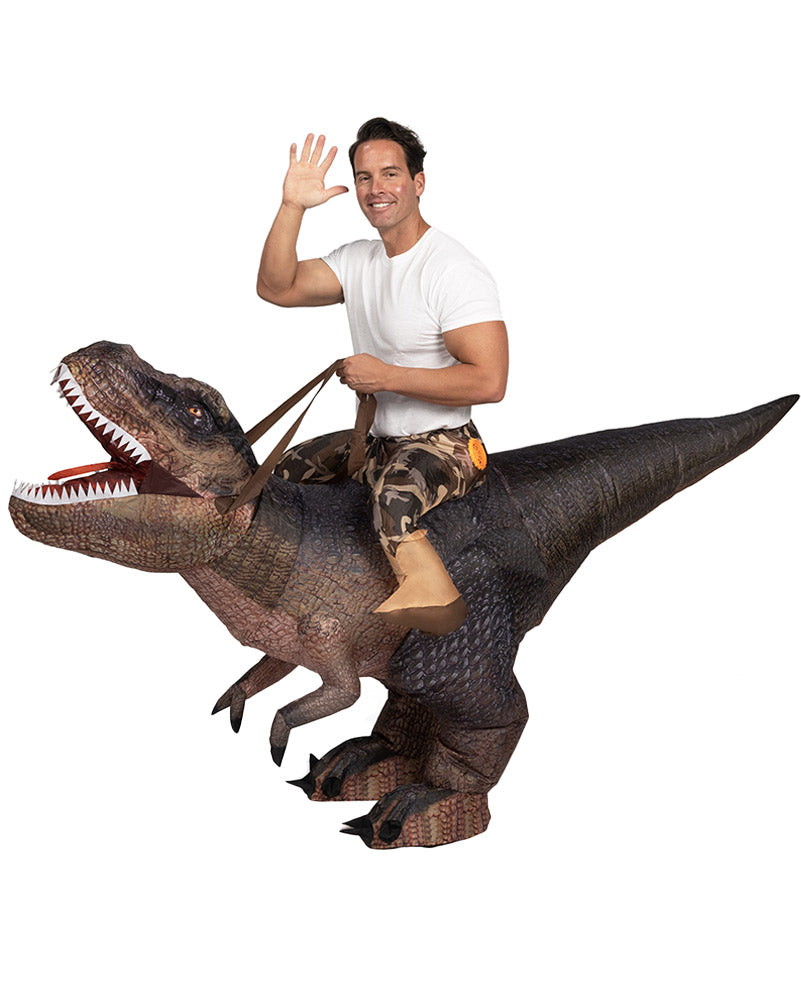 A person wearing an inflatable Tyrannosaurus Rex costume with printed brown T-rex detail and scales. The costume includes attached reigns and faux legs at the waist.