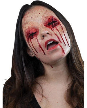 Person with dramatic makeup resembling blood and wounds on a white background
